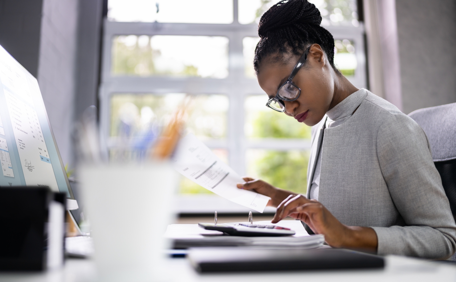 auditor at desk using calculator