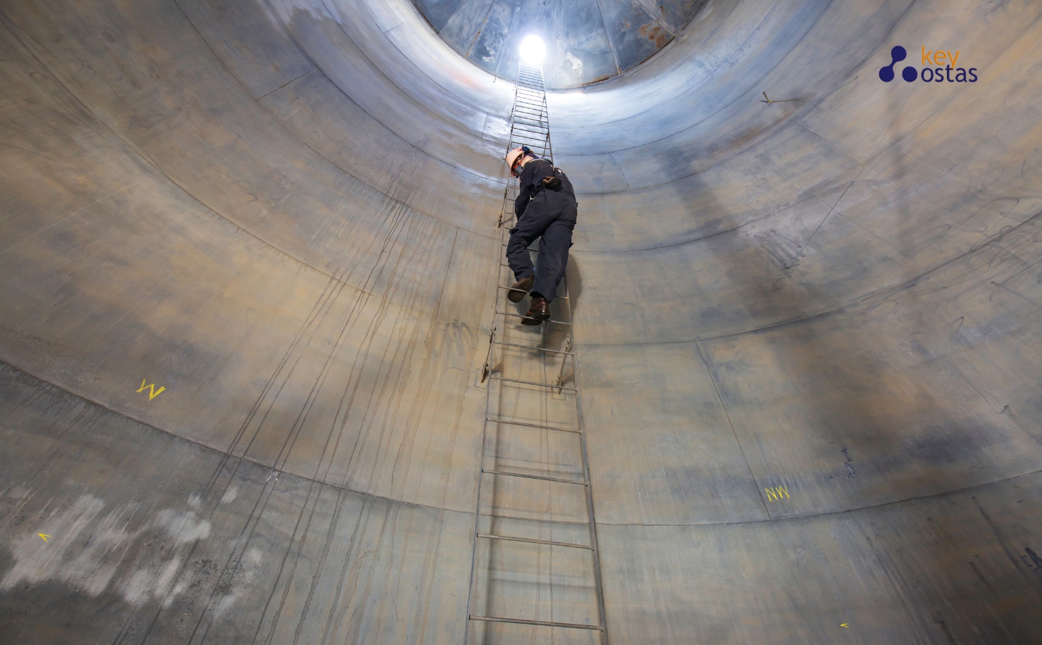 construction worker climbing up ladder from confined space