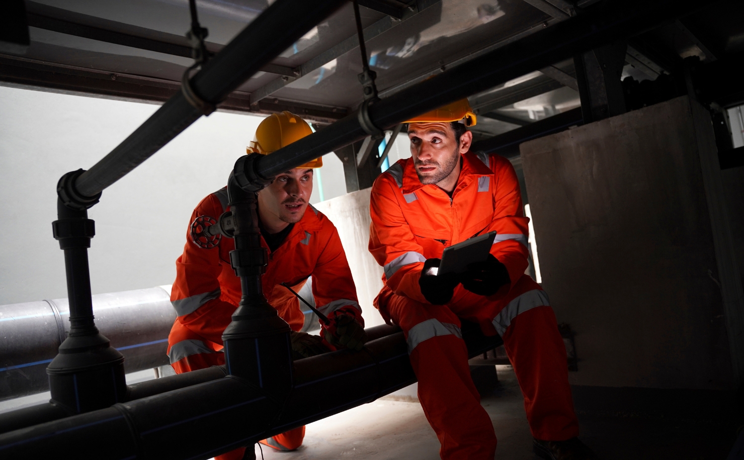 2 men working in confined construction space