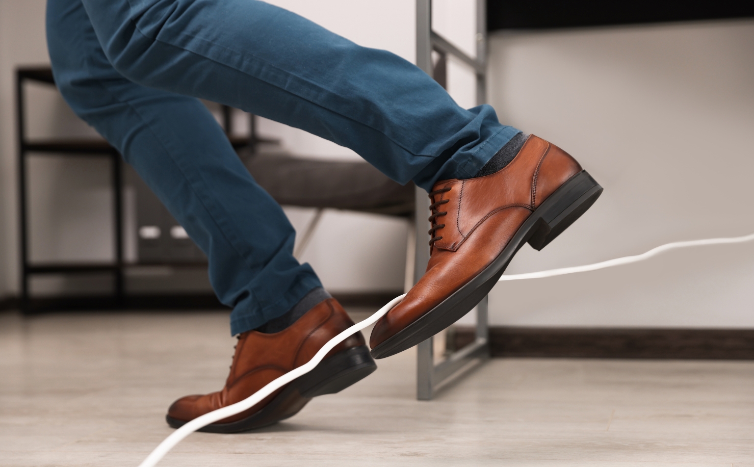 man tripping over cable in office